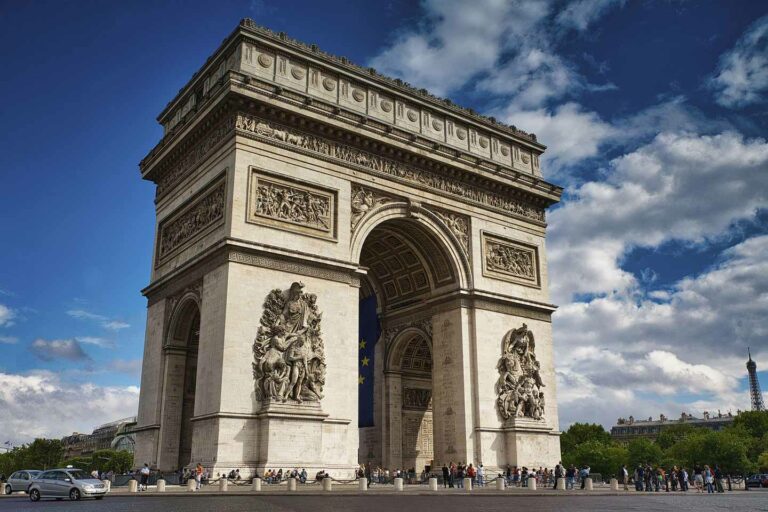 group of americans on tour at the arc de triomphe in paris
