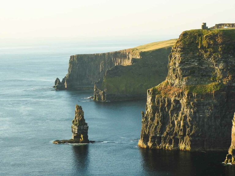 Breathtaking view of Cliffs of Moher, Ireland, showcasing dramatic sea cliffs and ancient rock formations at sunset