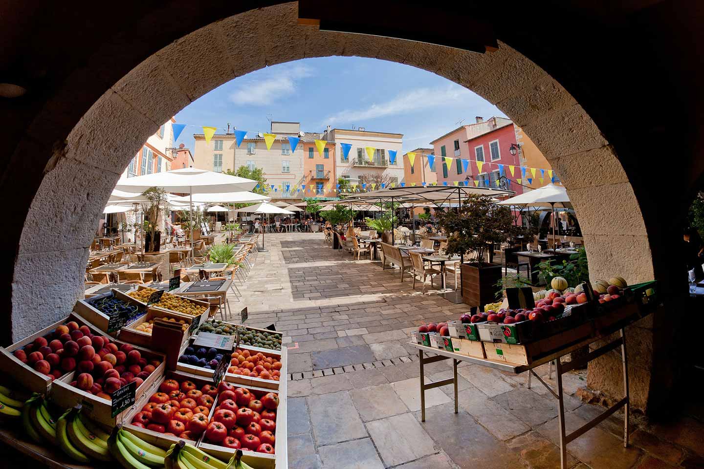 view under an arch of a market in the french riviera