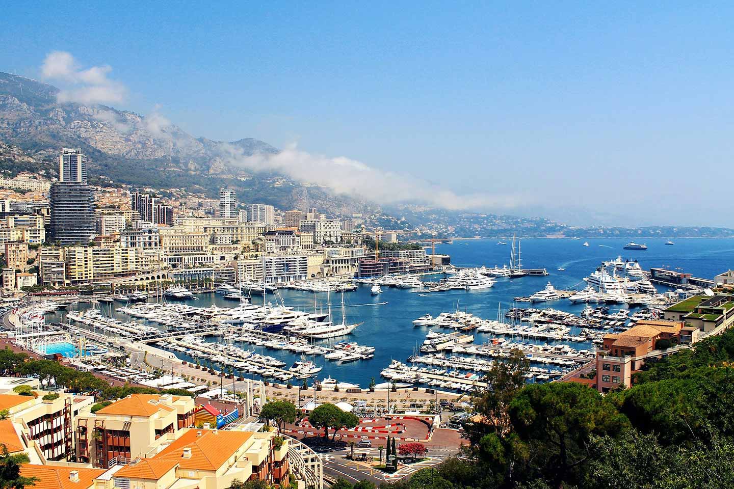 aerial view of monaco harbour lined with yachts and boats.