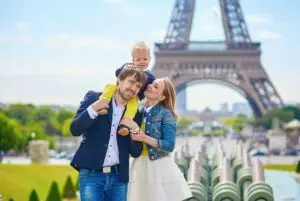 Happy family of three in Paris, France with Eiffel tower in the background