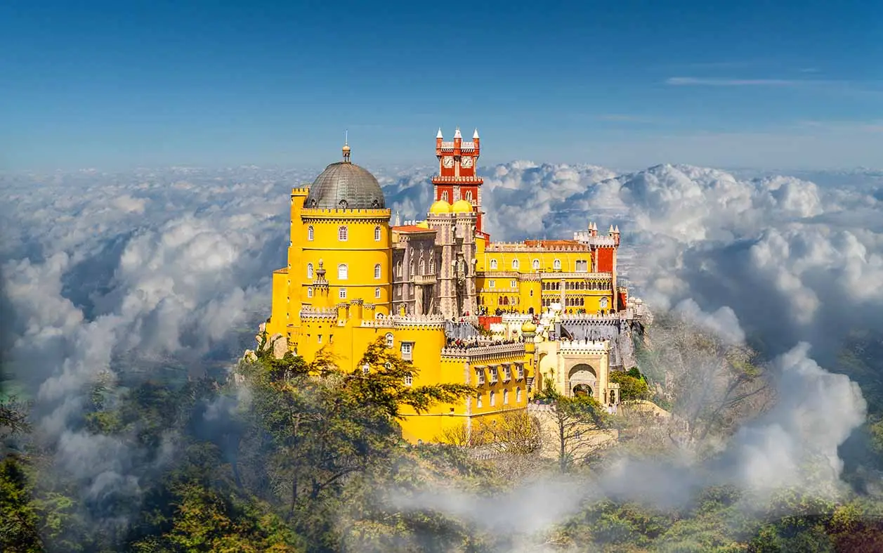 sintra castle yellow walls emerging from clouds