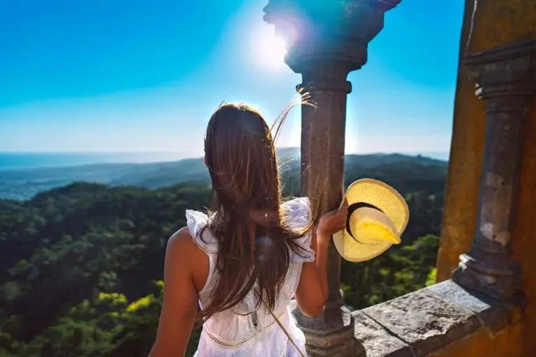 woman looking out over castle wall in Sintra, Portugal