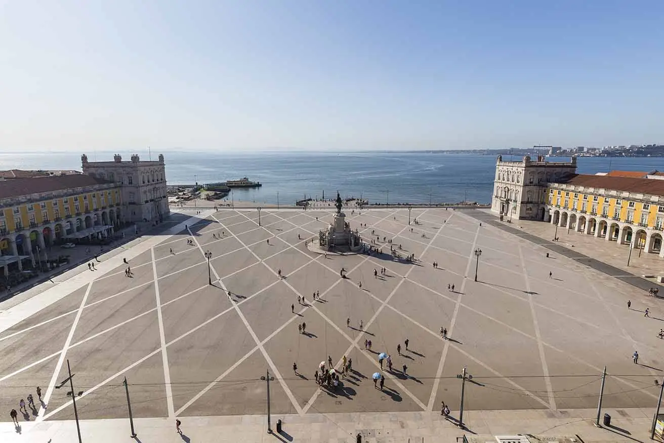 View of Tagus River and people and statue of King Jose I at the Praca do Comercio square in Baixa district in Lisbon, Portugal, from above on a sunny