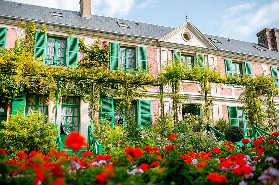 tour guide pointing at impressionist painting in Claude Monet's house in Giverny