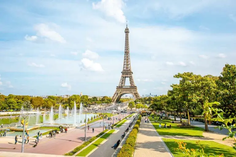 Tourists standing at base of Eiffel Tower with their private guide