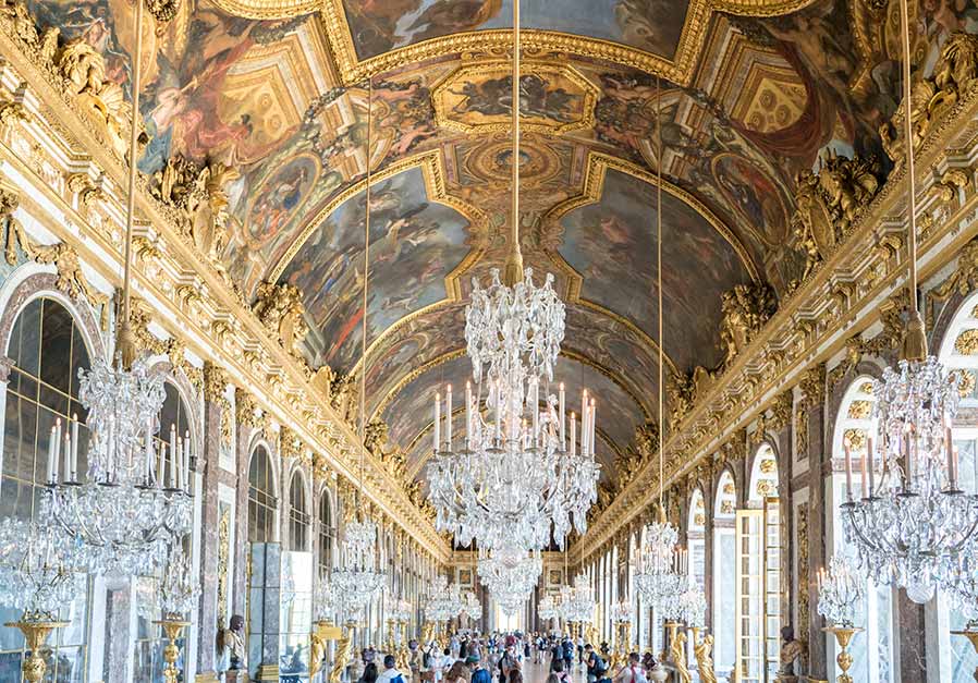 private guide leading excited tour group at Versailles, Hall of Mirrors